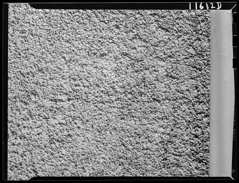 Texture background for motion picture and filmstrip. Pebbled stucco wall. Sourced from the Library of Congress.