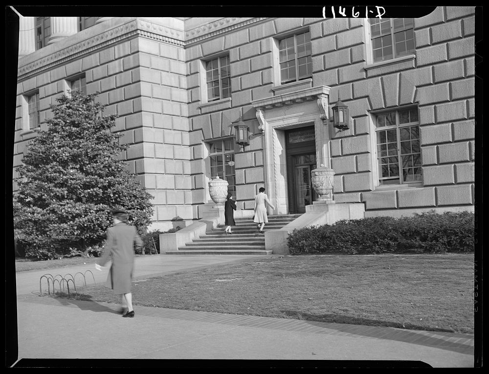 Washington, D.C. Government employees entering the 14th Street and Constitution Avenue entrance of the Department of…