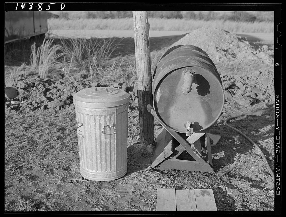 Trash container and fuel oil tank supplied to each trailer in camp. Trailer camp on U.S. 1 outside Alexandria, Virginia.…