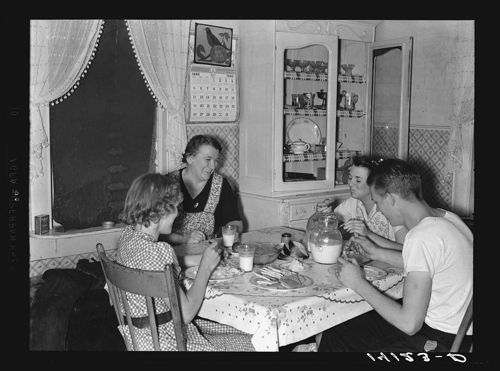 Mrs. Marinus W. Hansen, wife of Farm Security Administration rehabilitation farmer in Box Elder County, Utah, has dinner…