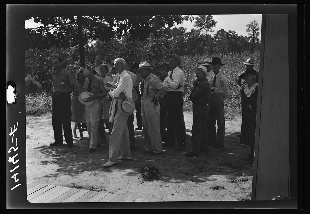 Group of businessmen listen to Farm Security Administration borrower tell of progress he has made. During the day this "Know…