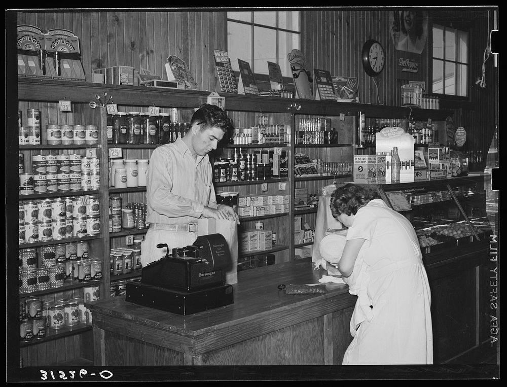 [Untitled photo, possibly related to: Making a purchase in cooperative stores. Lake Dick Project, Arkansas]. Sourced from…