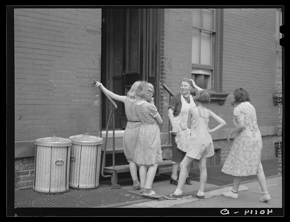New York, New York. 1938(?) A woman and girls at the back of an apartment house on East 63rd Street. Sourced from the…