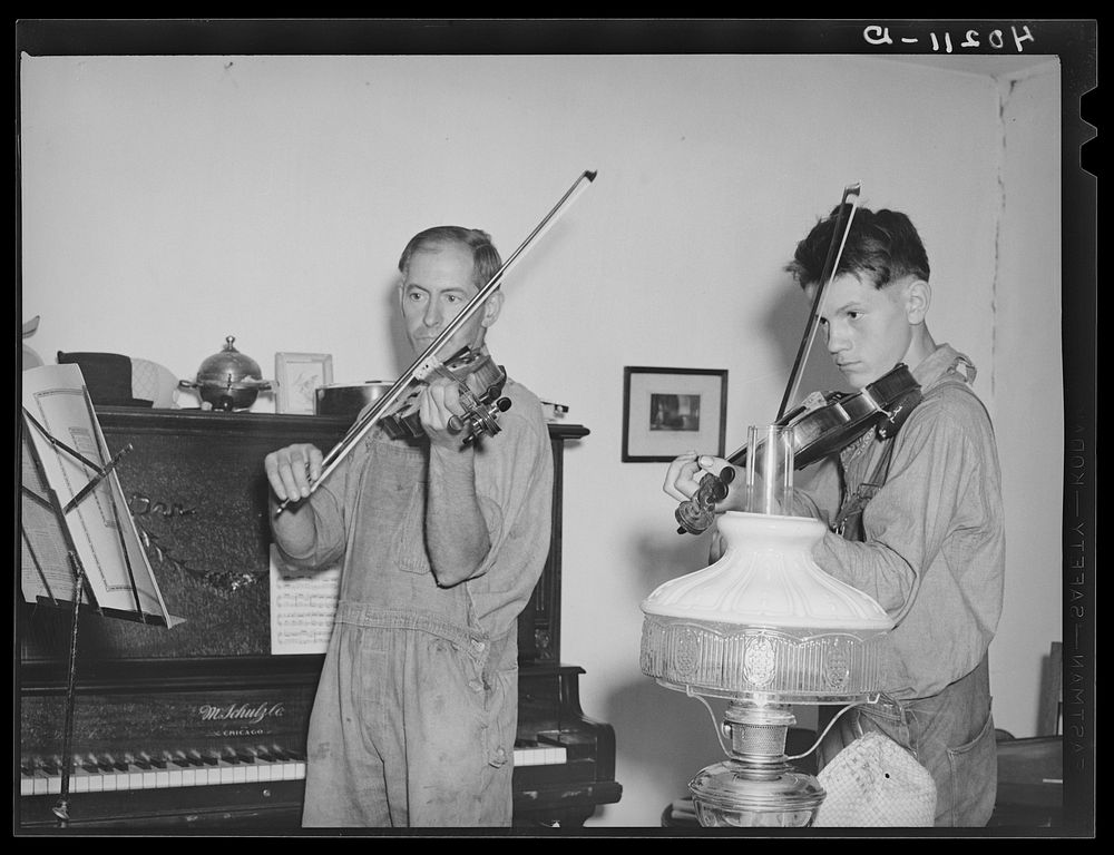 Barto, Berks County, Pennsylvania. Thomas Evans, a FSA (Farm Security Administration) client, giving a violin lesson to one…