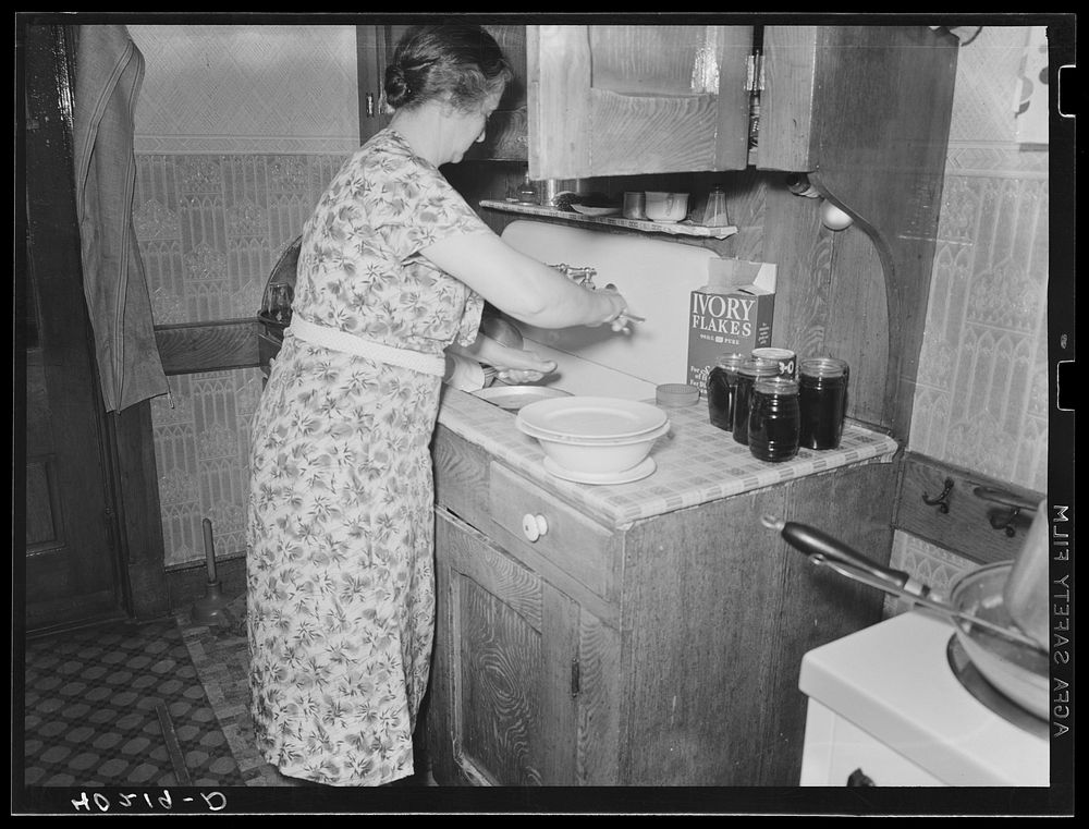 [Untitled photo, possibly related to: Lancaster County, Pennsylvania. Mr. [i.e. Mrs.] Royer peeling potatos on the Enos…