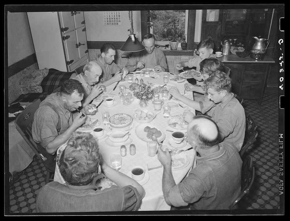 Lancaster County, Pennsylvania. Enos and Herbert Royer and the farm hands having dinner on the farm of Enos Royer. Three of…