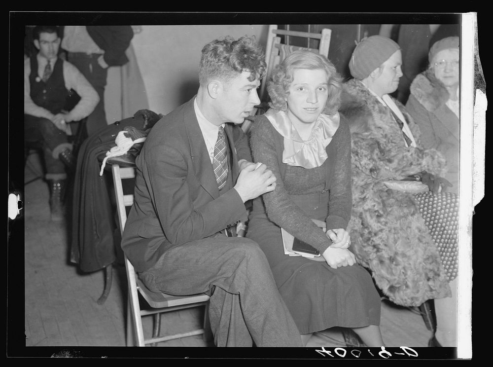 Striker and his fiancee (sitdown strike romance) in the Women's Auxiliary room in Pengally Hall. Flint, Michigan. Sourced…