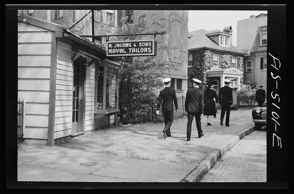 U.S. Naval Academy, Annapolis, Maryland. Midshipmen passing by a naval tailor's shop in Annapolis. Sourced from the Library…