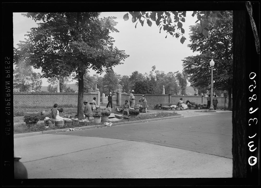 Washington, D. C. Flower vendors at the gate of the Congressional Cemetery on Memorial Day. Sourced from the Library of…