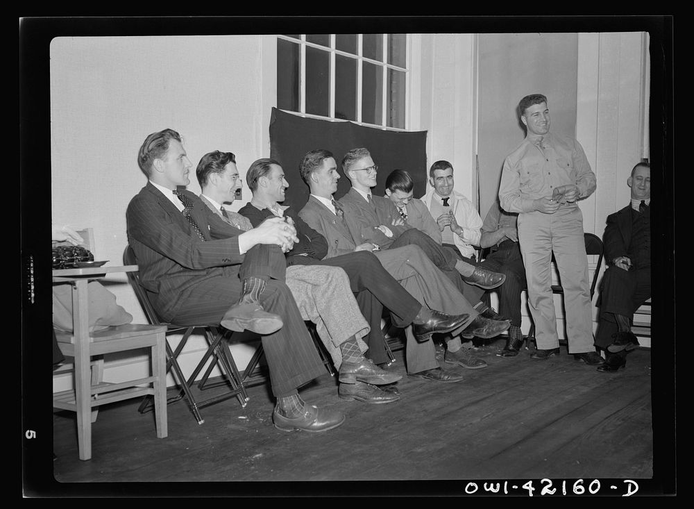 Southington, Connecticut. A group of young men soon to leave for army induction camps are listening to William Mongelo, of…