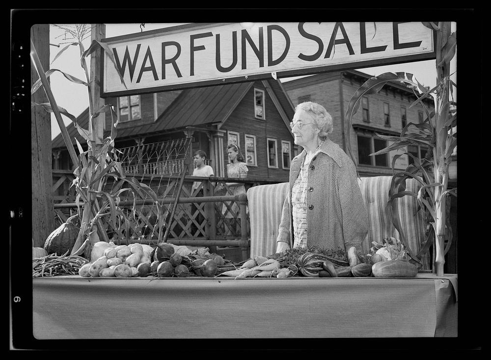 Hardwick, Vermont. Mrs. ALice White at the Victory Store vegetable counter selling donated farm produce, the money from…