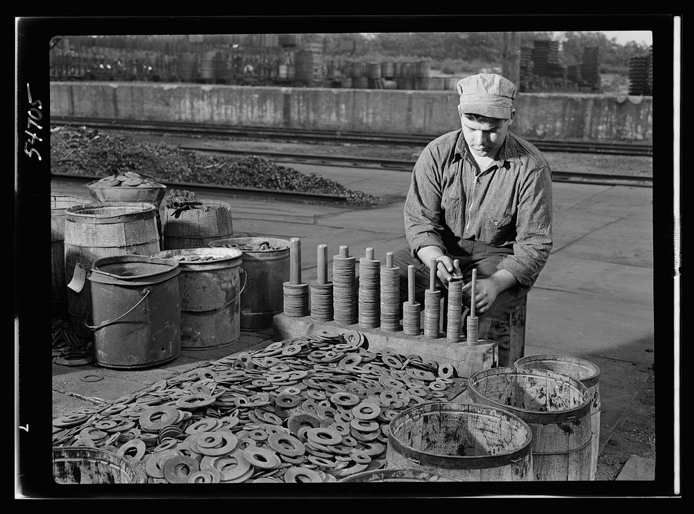 Boston and Maine railroad shops at Billerica, Massachusetts. Sorting iron washers according to size. Many of these will be…