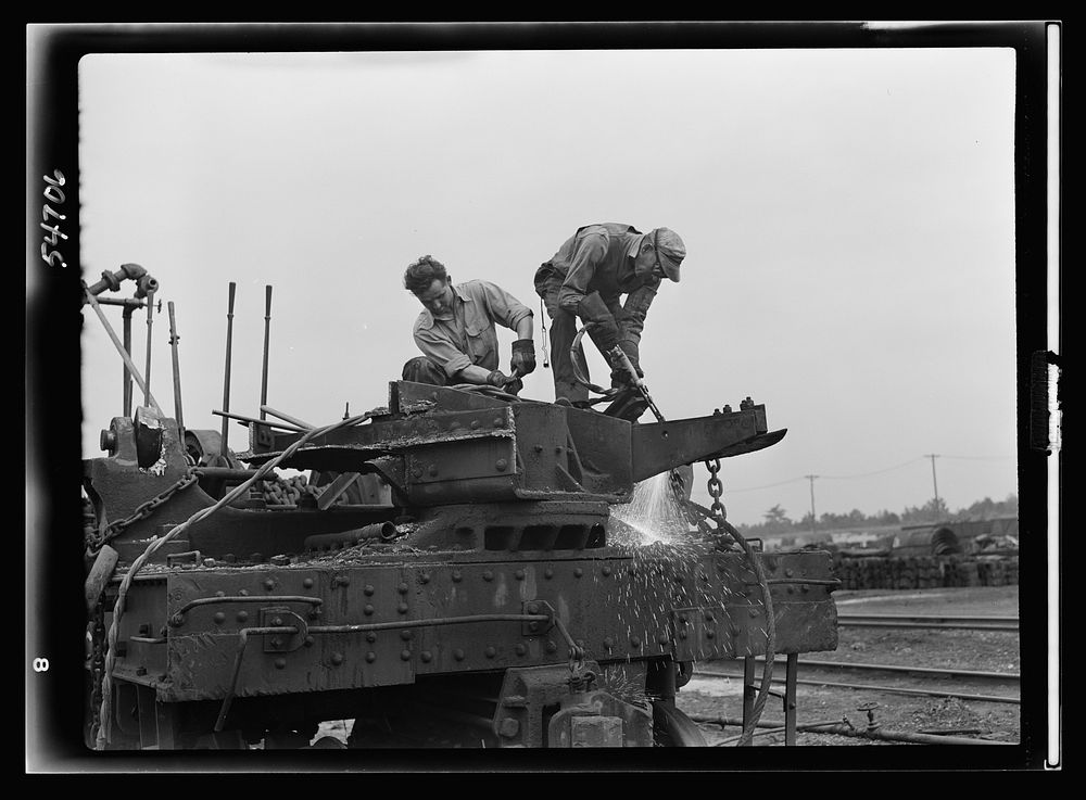 Boston and Maine railroad shops at Billerica, Massachusetts. Dismantling a railroad wrecking crane. Sourced from the Library…