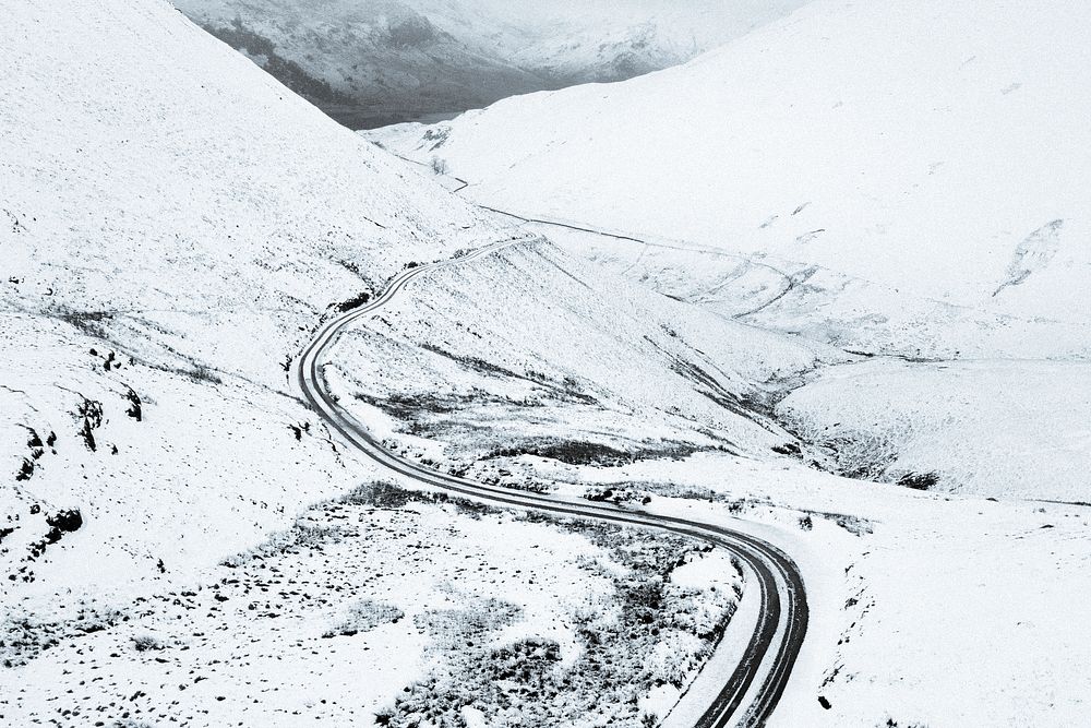 Drone shot of a snowy route of Newlands Pass at the Lake District, England