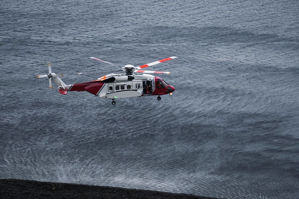 Coastguard helicopter flying over the sea in Scotland