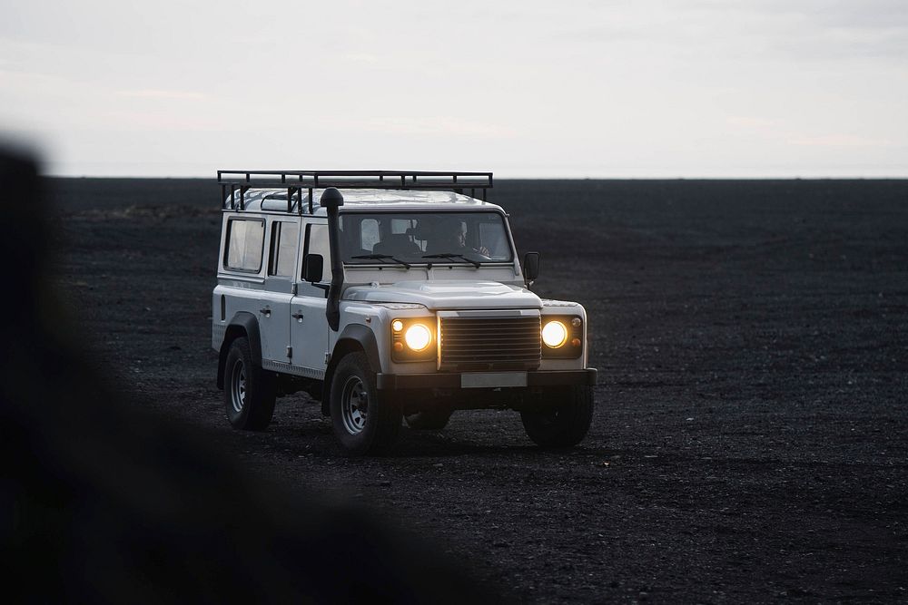 Car driving on the black sand beach, Iceland