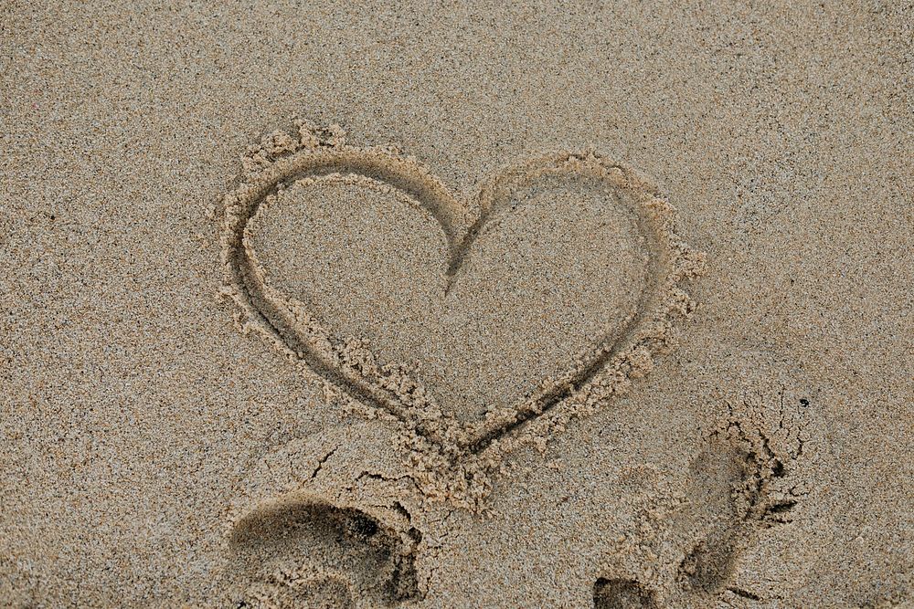 Drawing heart on the beach