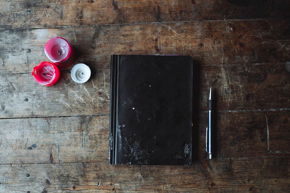 Journal on a wooden table in a forest cabin