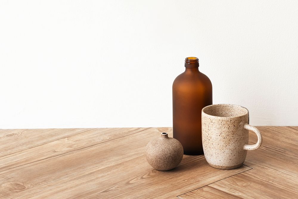 Minimal coffee cup by a brown vase on wooden floor