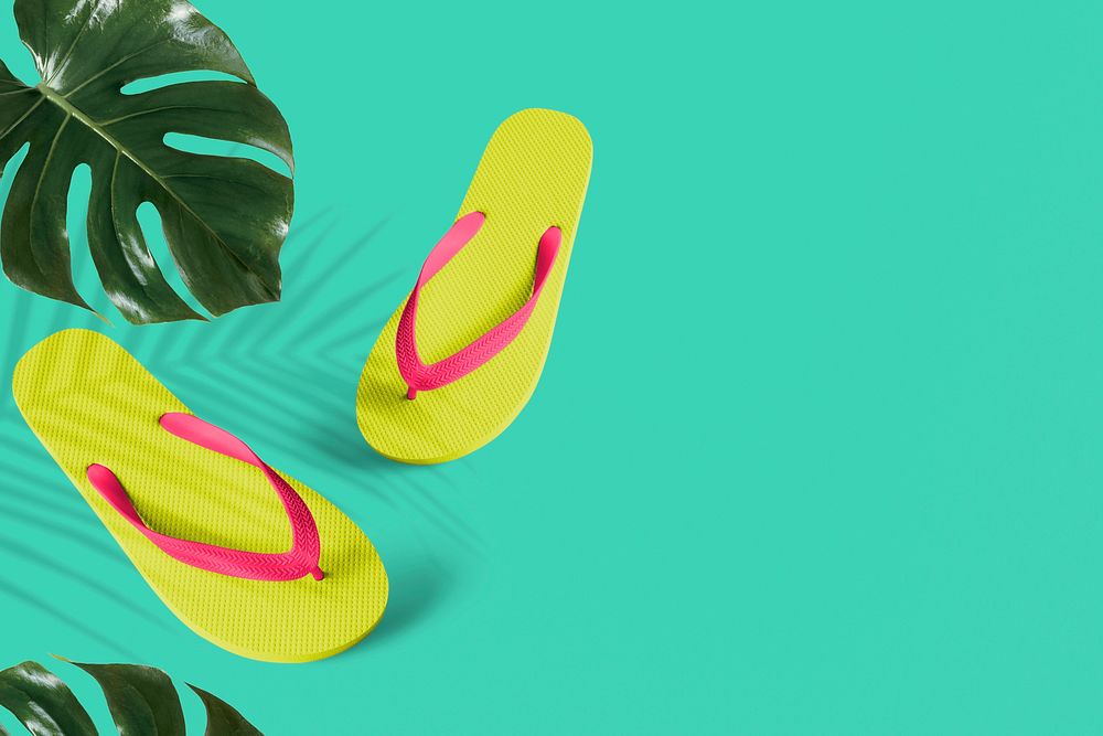 Lime green flip-flops on tropical background