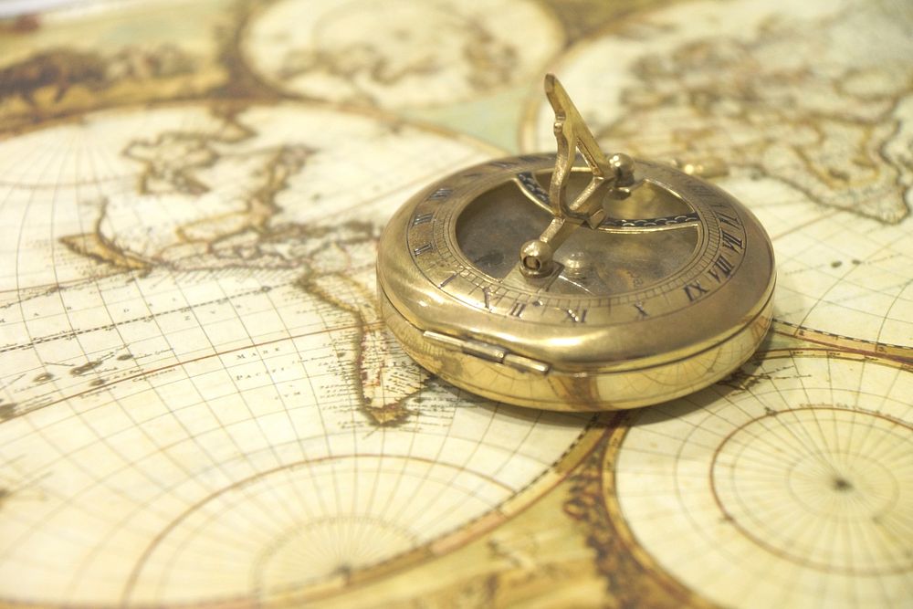 Golden compass on map, free public domain CC0 image.