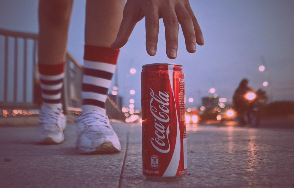 Coca Cola can on a street with hand approaching, location unknown, 28/10/2018