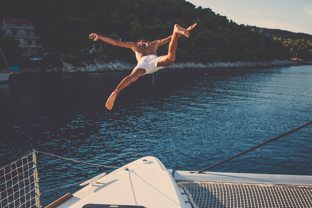 Free man jumping into the sea from a boat image, public domain CC0 photo.