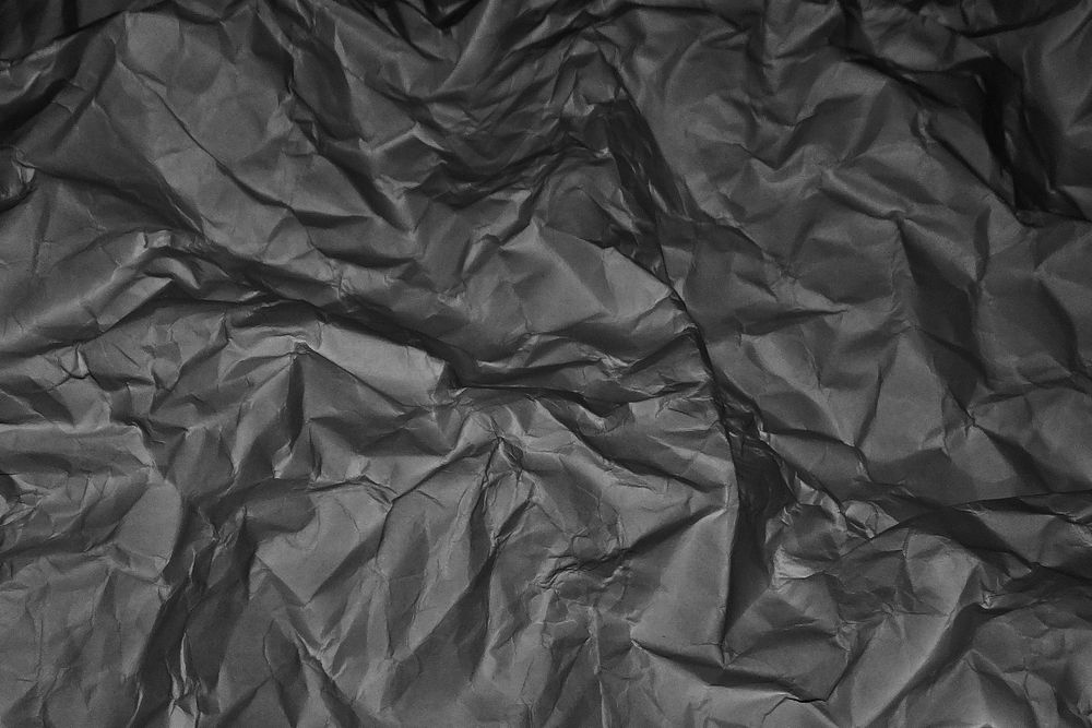 Crumpled black paper texture background, abstract design