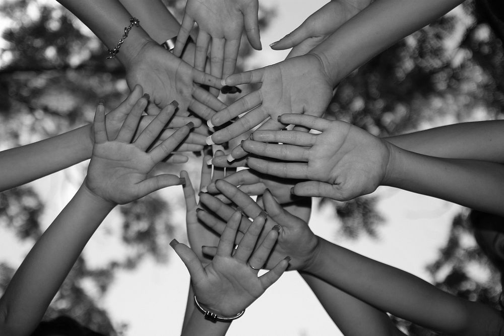 Free people joining hands image, public domain CC0 photo.