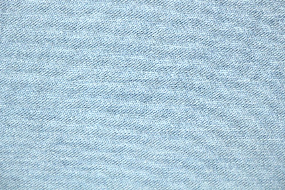 Blue denim background with a seam. Light blue color denim jeans fabric  texture. Copy space for text Stock Photo - Alamy