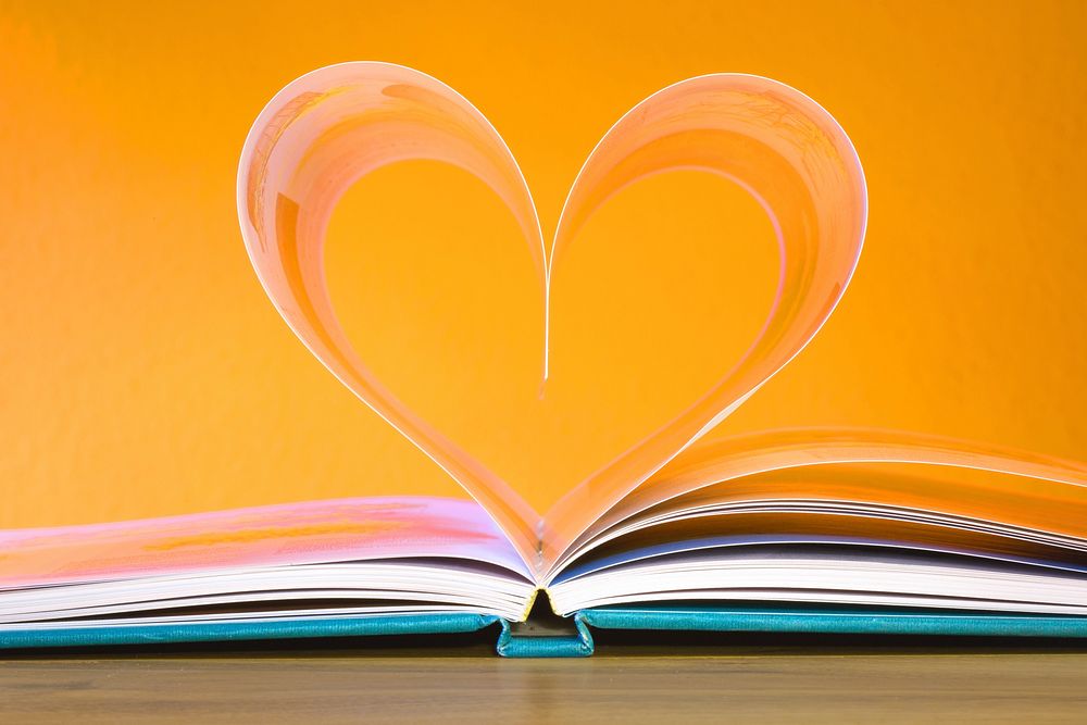 Free open book with heart shaped pages photo, public domain CC0 image.