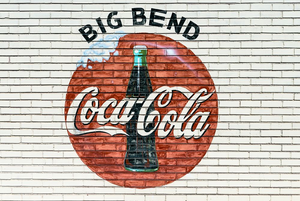 An old company sign appears on the wall of a Coca-Cola bottling plant outside Alpine, Texas. Original image from Carol M.…