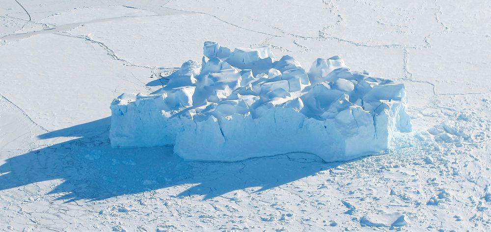 An iceberg embedded in sea ice as seen from the IceBridge DC-8 over the Bellingshausen Sea on Oct. 19, 2012. Original from…