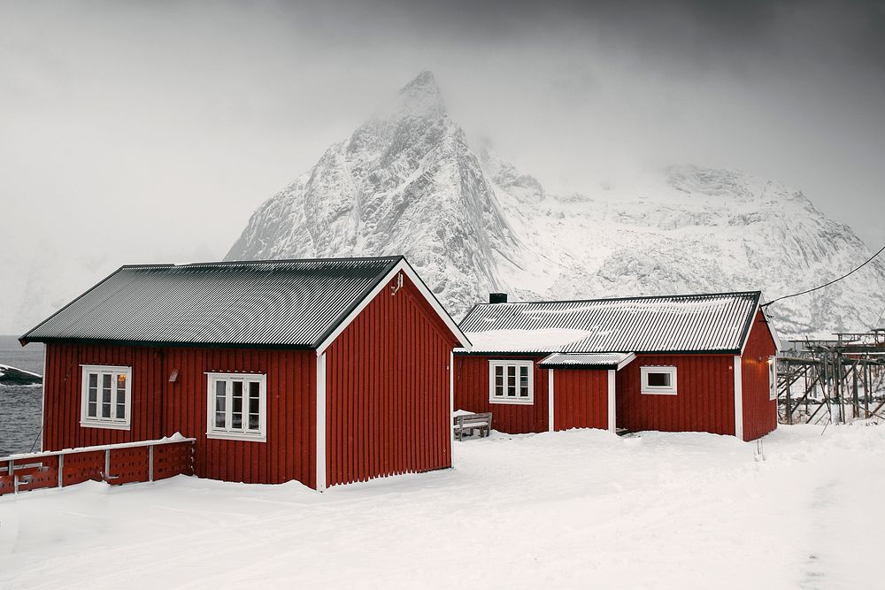 Red cabins on a snowy Sakrisoy island, Norway