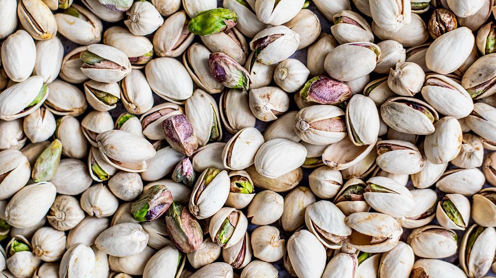 Fresh salted pistachio nuts background