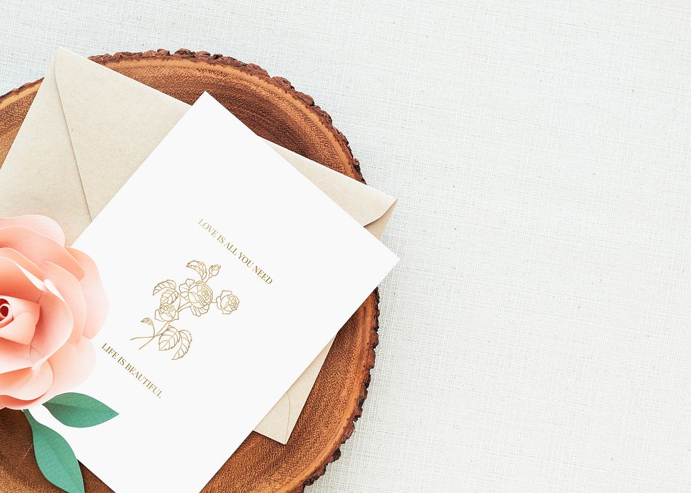 Wedding card with rose on a wooden plate