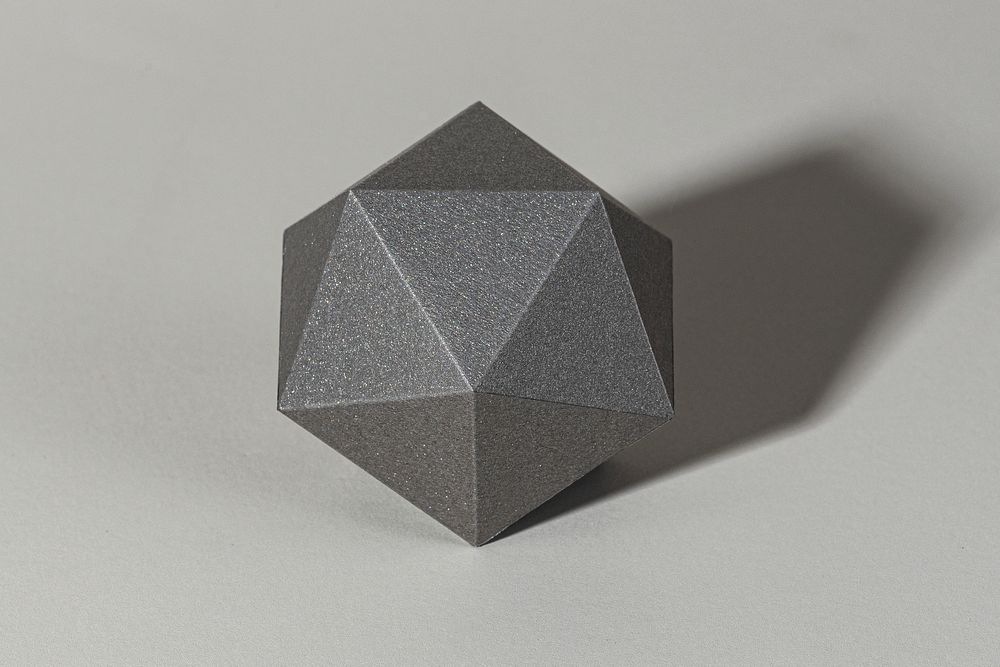 3D gray pentagon shaped paper craft on a gray background