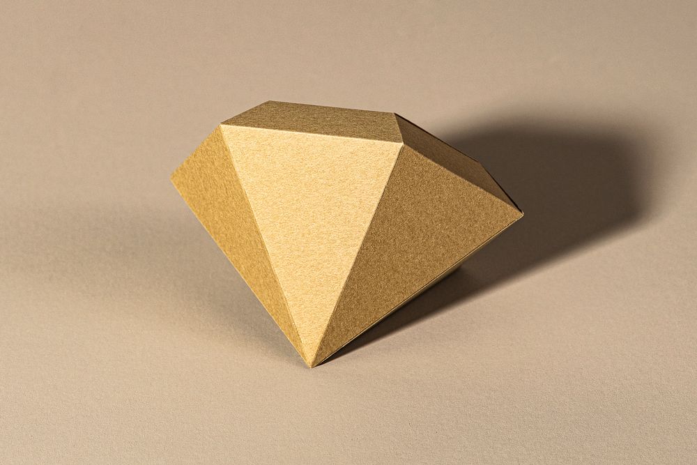 3D golden diamond shaped paper craft on a beige background