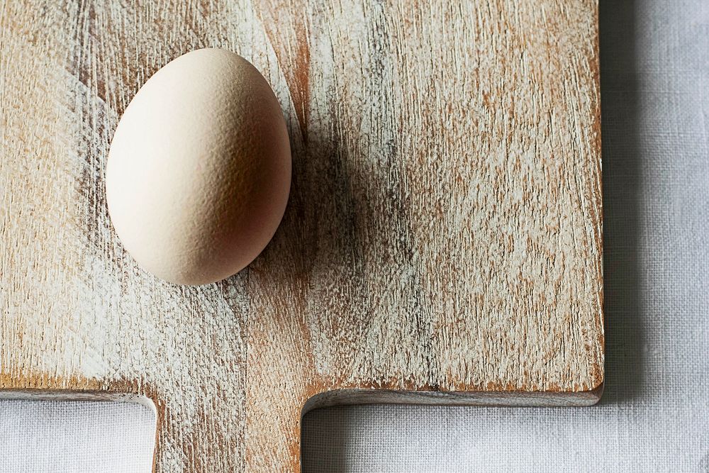 Fresh organic egg on a wooden board