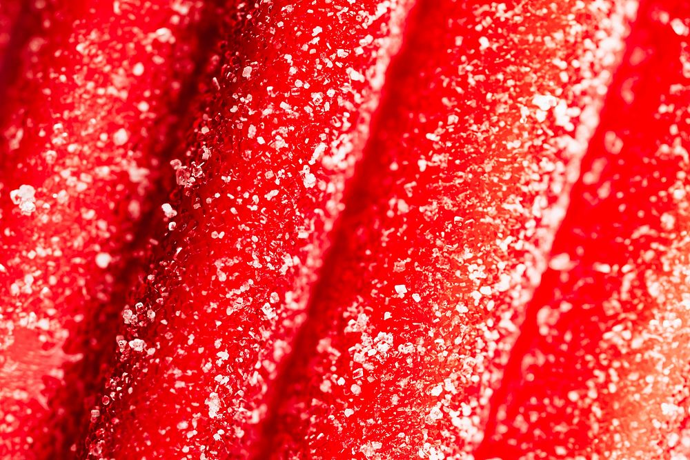 Red chewy candies coated with sugar