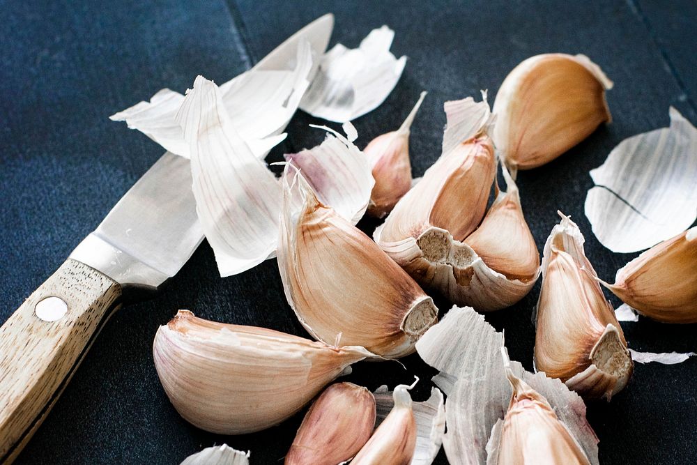 Natural fresh garlic and a knife on a table