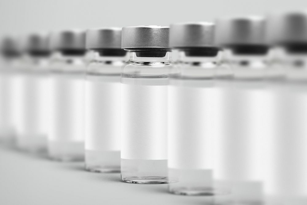 Vaccine injection bottles with white label in a row