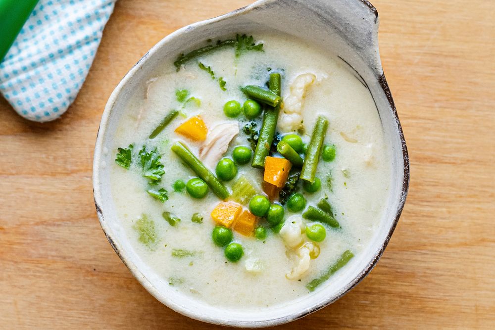 Kids healthy chicken soup with peas and carrots 