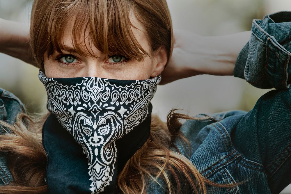 Woman covering her mouth with a bandana during coronavirus outbreak 