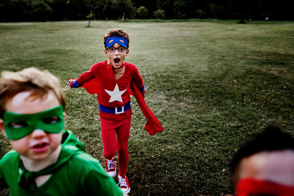 Superhero kids playing at the park