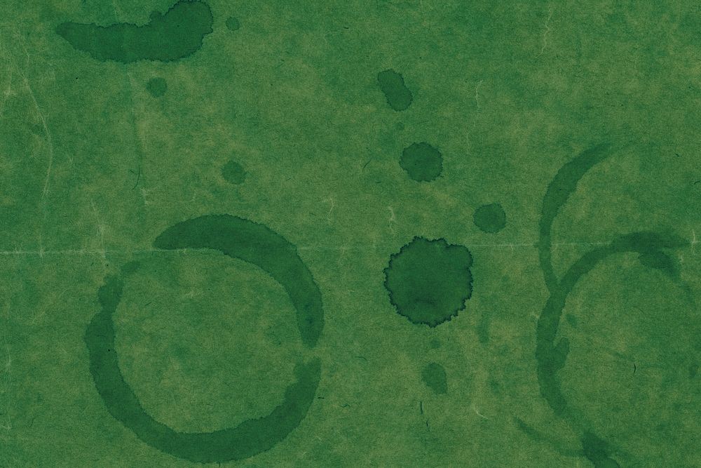 Stains on a green paper textured background