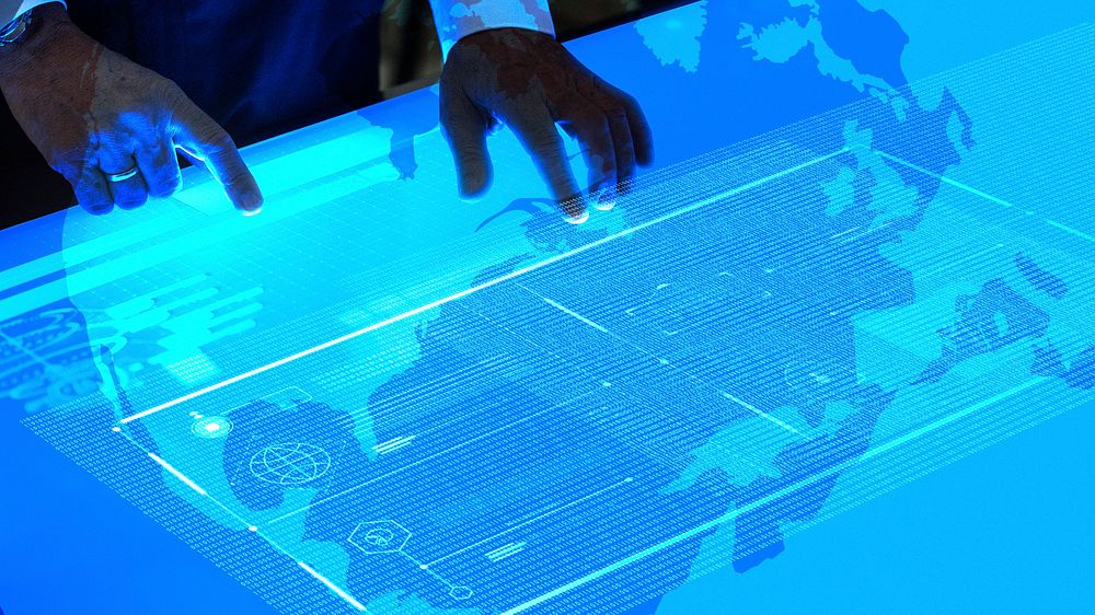 Man using a flat blue touchscreen computer