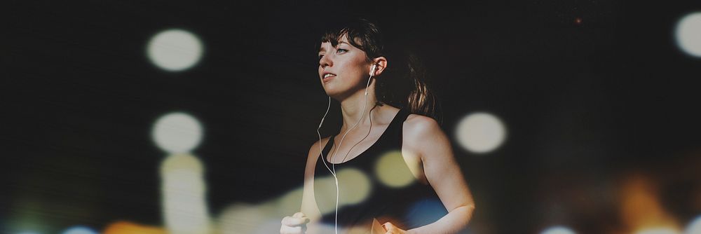 Sporty woman running in a dark alley social banner