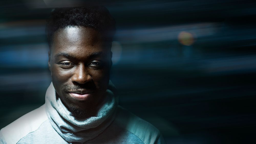 Happy black man wearing a turtle neck top