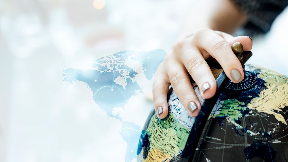 Woman touching a desk globe ball